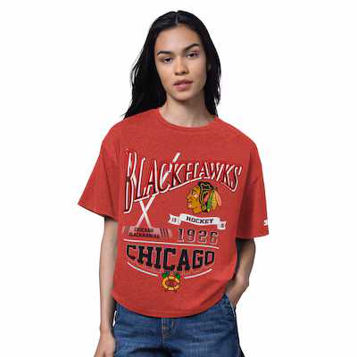 A person wearing a red Chicago Blackhawks t-shirt with team logo and text, standing against a plain white background.