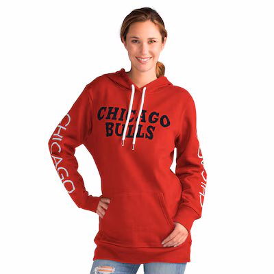 Woman wearing a red Chicago Bulls hoodie with "CHICAGO BULLS" on the front and "CHICAGO" printed on both sleeves, standing and smiling.