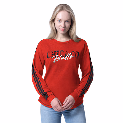 Woman wearing a red long-sleeve Chicago Bulls sweatshirt with black stripes on the sleeves, standing against a white background.