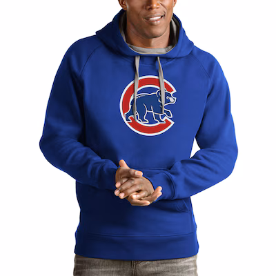 cubs-mens-sweatshirts Man wearing a blue hoodie with a Chicago Cubs bear logo on the front, standing with hands clasped.